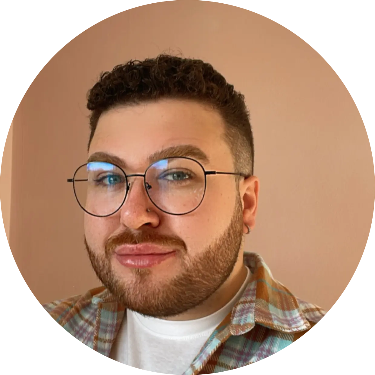 The image features Kieron, a member of the Harmony Voyages team, smiling at the camera. He has short, dark hair and is dressed in a smart, professional outfit. Kieran exudes a friendly and approachable demeanor, making him appear confident and engaged.